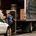 Movers carefully packing the back of a moving van