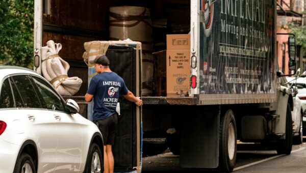 Movers carefully packing the back of a moving van