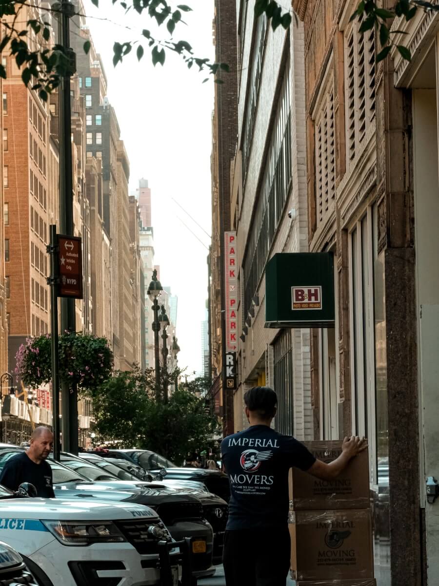 A professional moving team moving boxes from an apartment building 